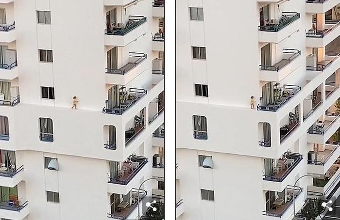 Thót tim cảnh bé gái lao băng băng trên gờ tường chung cư